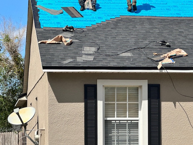 roof repairs on black shingle roof